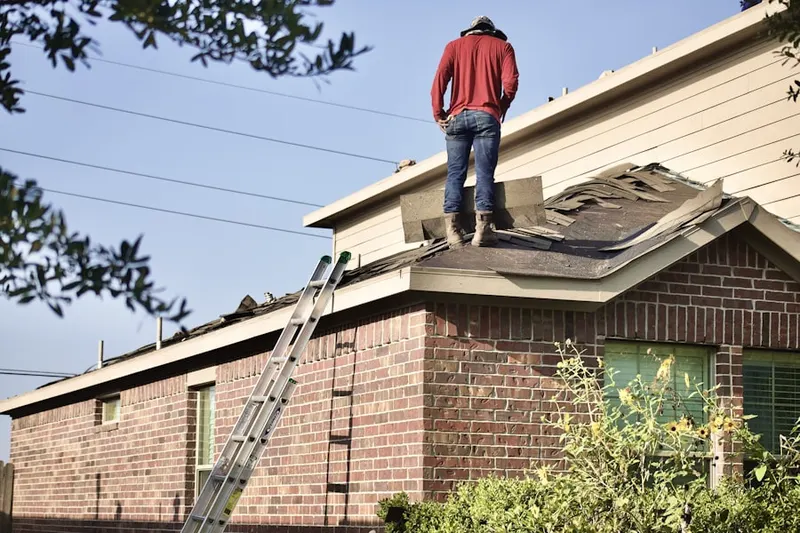 Professional roofer working on a residential roof in Brush